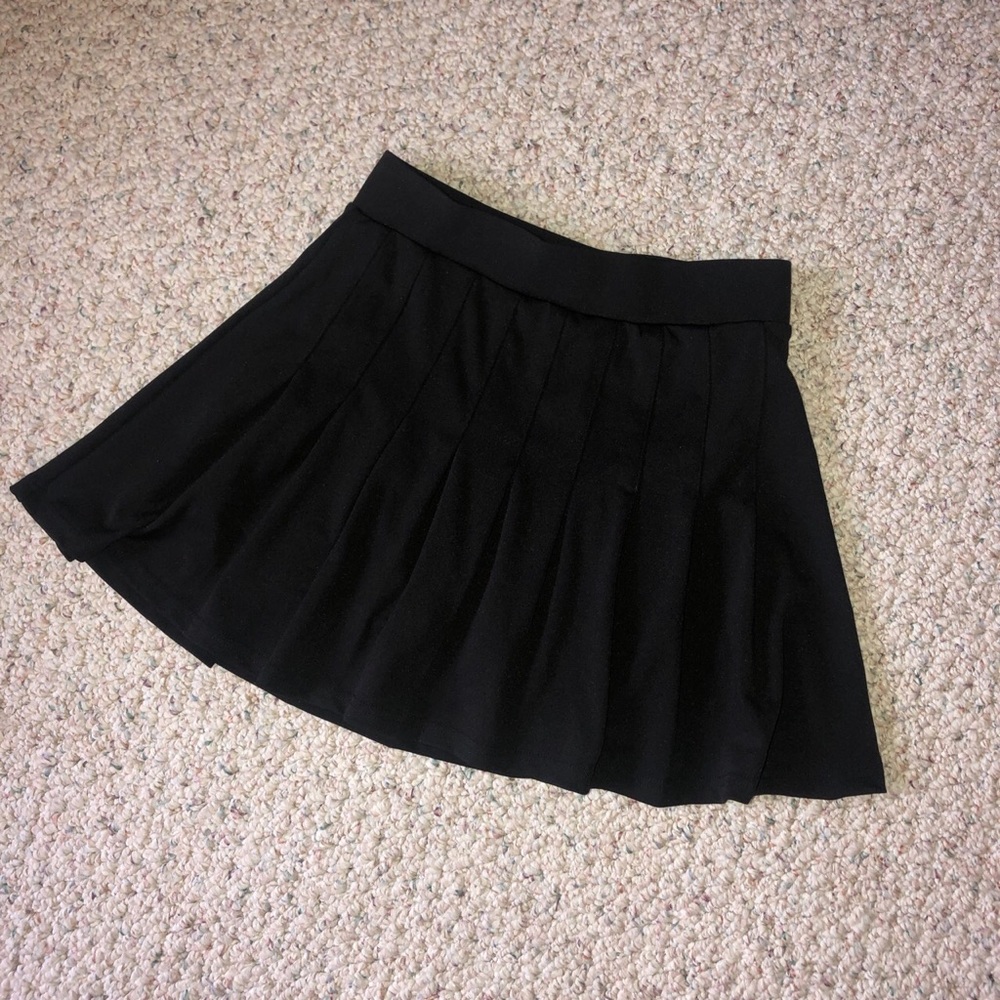 Black pleated skirt. It has built in shorts. Perfect for exercising.